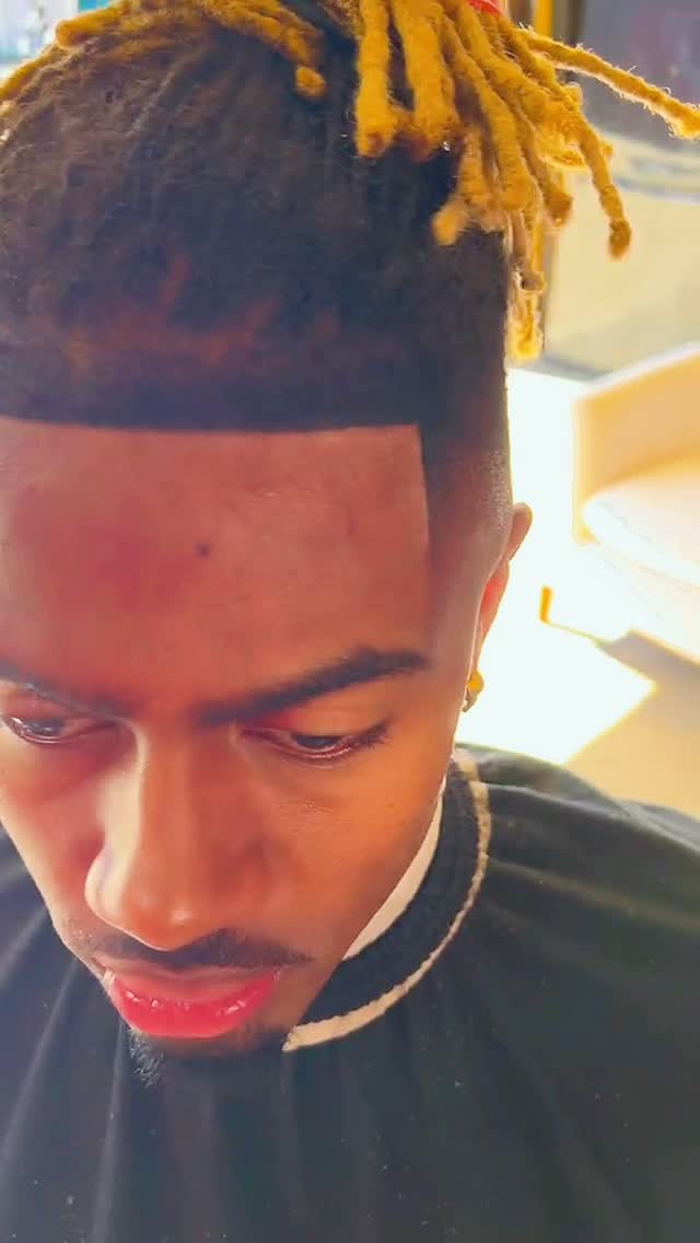 Razor-sharp front lineup with blond-tipped locs